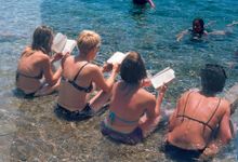 Participants reading and relaxing in the sea