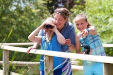 Family spotting wildlife at a WWT Wetland Centre