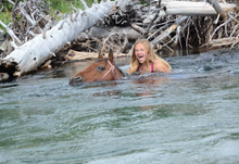 girl swimming with horse, Sweet Grass Guest Ranch, Montana