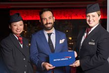Tim Philips receiving his prize of a return Club world business class ticket to London from British Airways ambassadors