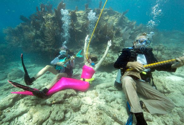 Participants pretend to play mock musical instruments and enjoy the Lower Keys Underwater Music Festival Saturday, July 12, 2014