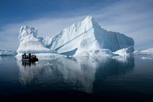 Zodiac cruising giant icebergs in Antarctica
