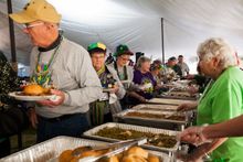 Guests at the 9th Annual Red River Mardi Gras Bash line up for Cajun and Creole cuisine, which is served throughout the day.
