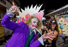 Revelers dressed as comic-book villains proceed down Duval Street Saturday, Oct. 25, 2014, in Key West, Fla., during the Fantasy