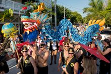 A 20-foot long Japanese-style dragon is carried down Fleming Street Friday, Oct. 24, 2014, in Key West, Fla., during the Fantasy