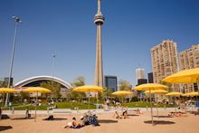Sunbathing in the shadow of the CN Tower, Toronto, Ontario