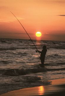 Surf fishing at sunset on the Gulf Coast beaches of Southwest Louisiana