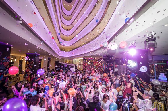 Balloons and confetti fly in the lobby, dubbed “Meeting Point”