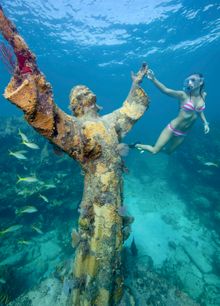 Snorkeler Katherine Wieland examines the Christ of the Abyss statue in the Florida Keys National Marine Sanctuary off Key Largo,
