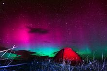 Camping with a hot chocolate and the Northern Lights