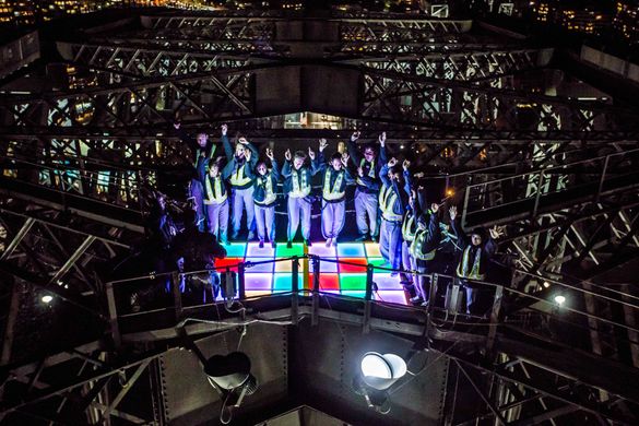 Climbers on The Vivid Climb 2016 dancing on a 70s style Disco Dance Floor at the top of the Sydney Harbour Bridge