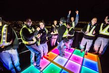 Climbers on The Vivid Climb 2016 dancing on a 70s style Disco Dance Floor at the top of the Sydney Harbour Bridge_Close up form 