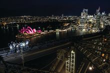Climbers on The Vivid Climb 2016 in flashing jackets on the Sydney Harbour Bridge_Opera House background 