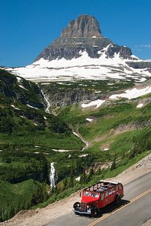 A red bus tour in Glacier National Park.