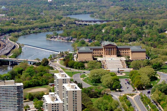 An aerial view of the Philadelphia Museum of Art with Boathouse Row and the Schuylkill River in the background.