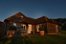 Sempstead Cottage bathed in early morning summer sunshine 