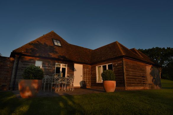 Sempstead Cottage bathed in early morning summer sunshine 