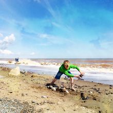 Playing on Tunstall Beach by Sand le Mere, taken on a smartphone by Elaine Taylor