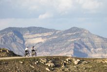 Mountain bikers on easy trail into grandiose scenery near Fruita