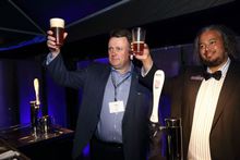 Halifax Mayor Mike Savage and longtime Westin Nova Scotian bartender Jonathan Devereaux toast the hotel's 20th anniversary under