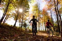 Cyclists enjoy the beauty of Maine's foliage season.