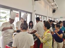Chef Andy Oh and associates from Pan Pacific Hotels Group serving up Singapore Laksa to the residents