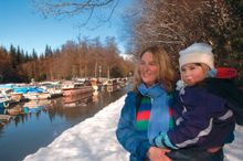 Parent & child by a snowy canal