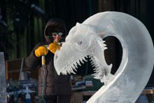 Steve Brice carves a dragon head from a block of ice (Sherman Hogue-Explore Fairbanks)