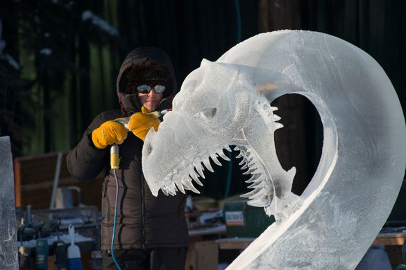 Steve Brice carves a dragon head from a block of ice (Sherman Hogue-Explore Fairbanks)
