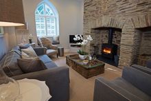 Cosy sitting room with double-fronted Inglenook fireplace at Hillfield Farmhouse, near Dartmouth