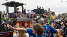 A float throws beads and toys in the Krewe of Highland Parade in Shreveport.