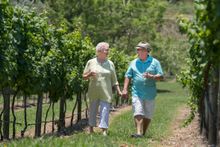 Mark and Allison Grant walk among the grapes at O'Reilly's Vineyard at Canungra, about 40 minutes west of Surfers Paradise. 