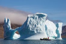 Zodiac cruising amongst the world's largest icebergs in Scorebsy Sund, Greenland