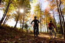 Cyclists enjoy the beauty of Maine's foliage season.