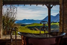 A bath with a view – soak up the scenery from Mahu Whenua Ridgeline Homestead & Eco Sanctuary near Queenstown. 