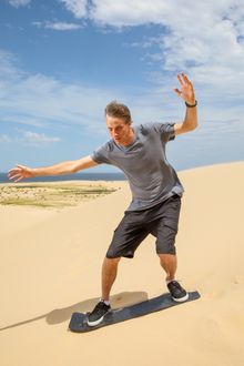 Tony Hawk sandboarding at Stockton Sand Dunes, Port Stephens