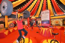 See how many skills you can show off - perhaps ride the unicycle while holding up the barbells?
