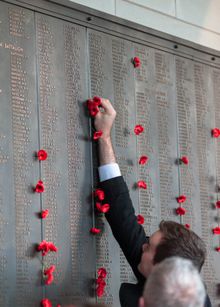 It is customary to place a poppy - the symbol of remembrance along the Roll of Honour
