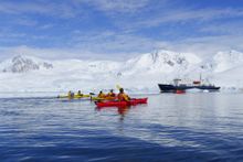 Kayaking in Antarctica with Polar Pioneer in background
