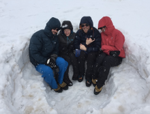 Team relax on mountainside in the Zagros mountains in Iraqi Kurdistan on an adventure travel expedition with Secret Compass