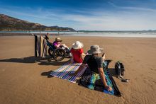 Family using a PV children's beach wheelchair
