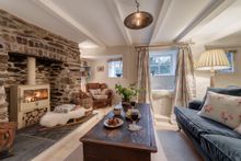 The cosy open-plan lounge with log fire