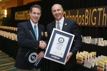 Philip Robertson, GUINNESS WORLD RECORDS adjudicator and George Aguel, President and CEO of Visit Orlando, celebrate the declaration of Visit Orlando as a GUINNESS WORLD RECORDS title holder as part of the launch of a new thank you campaign, on May 11 in 