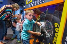 Intergenerational fun changing tires and learning about racing at Hot Wheels™: Race to Win™ 