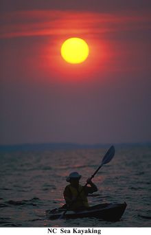 A sea kayaker paddles along the Outer Banks of North Carolina.