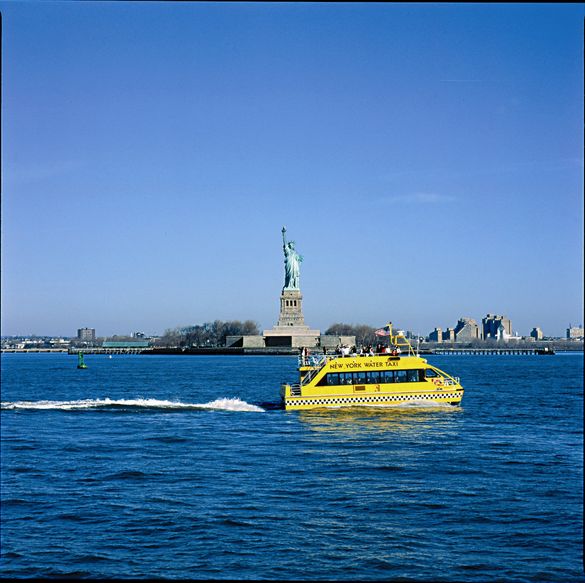 New York Water Taxi Passes the Statue of Liberty