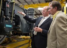 All Aboard Florida’s Myles Tobin (right) visits Siemens’ manufacturing facility in Sacramento, CA, where Siemens’ Michael Cahill (center) explains some of the technology that will be featured in All Aboard Florida’s new rolling stock.