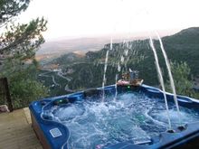 Soak in your own hot tub and watch the sun go down