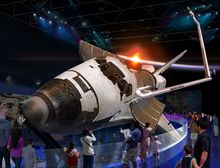 WORKING IN SPACE - Guests get a 360-degree view of Space Shuttle Atlantis as only astronauts have seen it before, tilted on its 