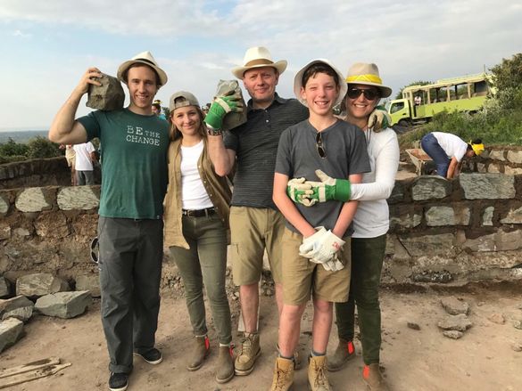 Left to right: Craig Kielburger, Ella Tollman, Brett Tollman, Jake Tollman, and Miranda Tollman working on a community development project during a ME to WE immersive volunteer trip in Kenya 